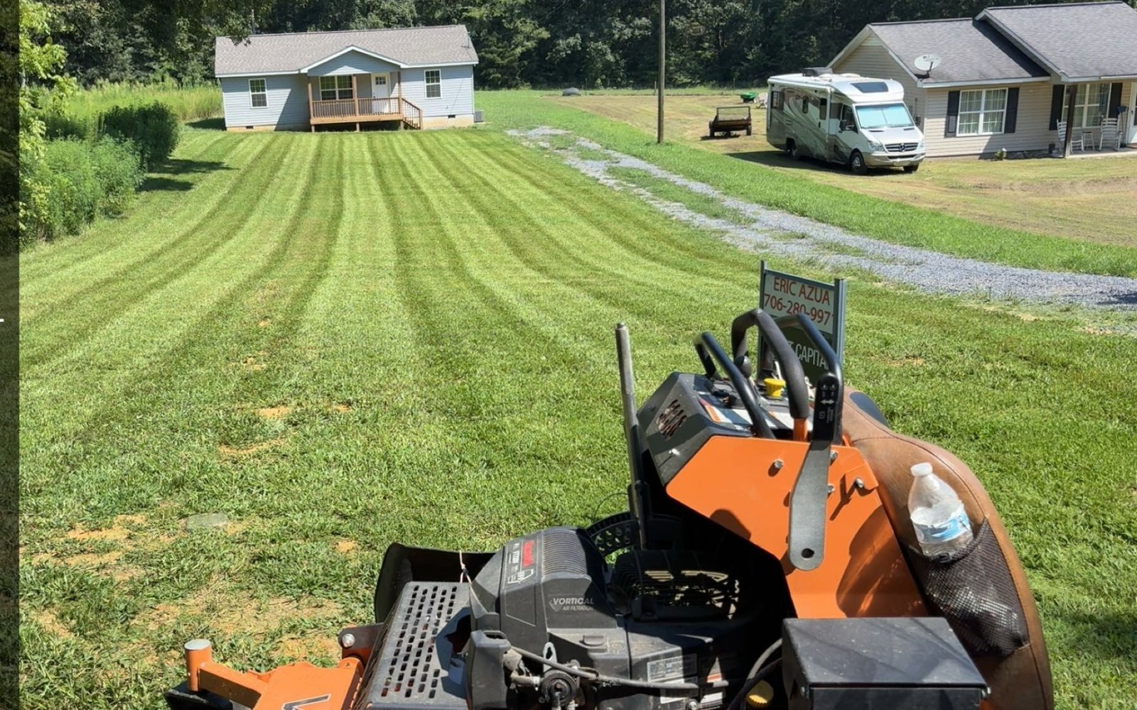 Mower on a residential property with lawn stripes